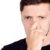 a man holding his nose