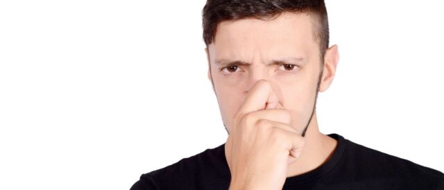 a man holding his nose